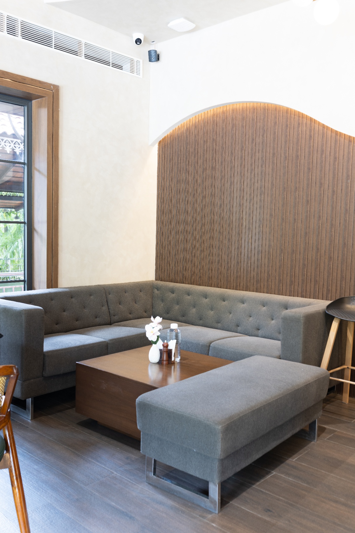 D'Scops Café sofa corner with soft seating, wood panel feature, and relaxed café mood
